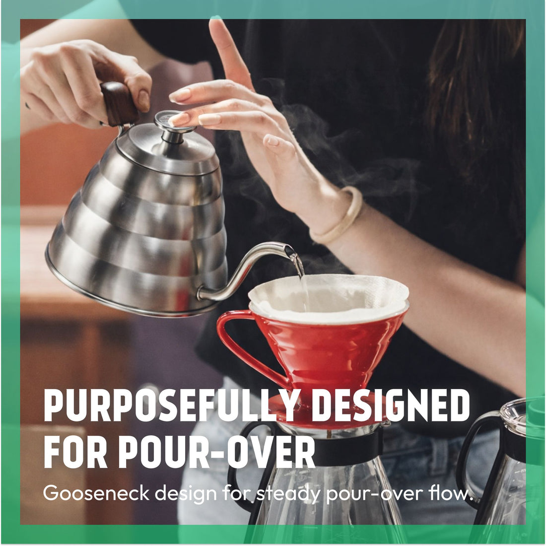 Pouring hot water from a gooseneck kettle into a red pour-over coffee dripper