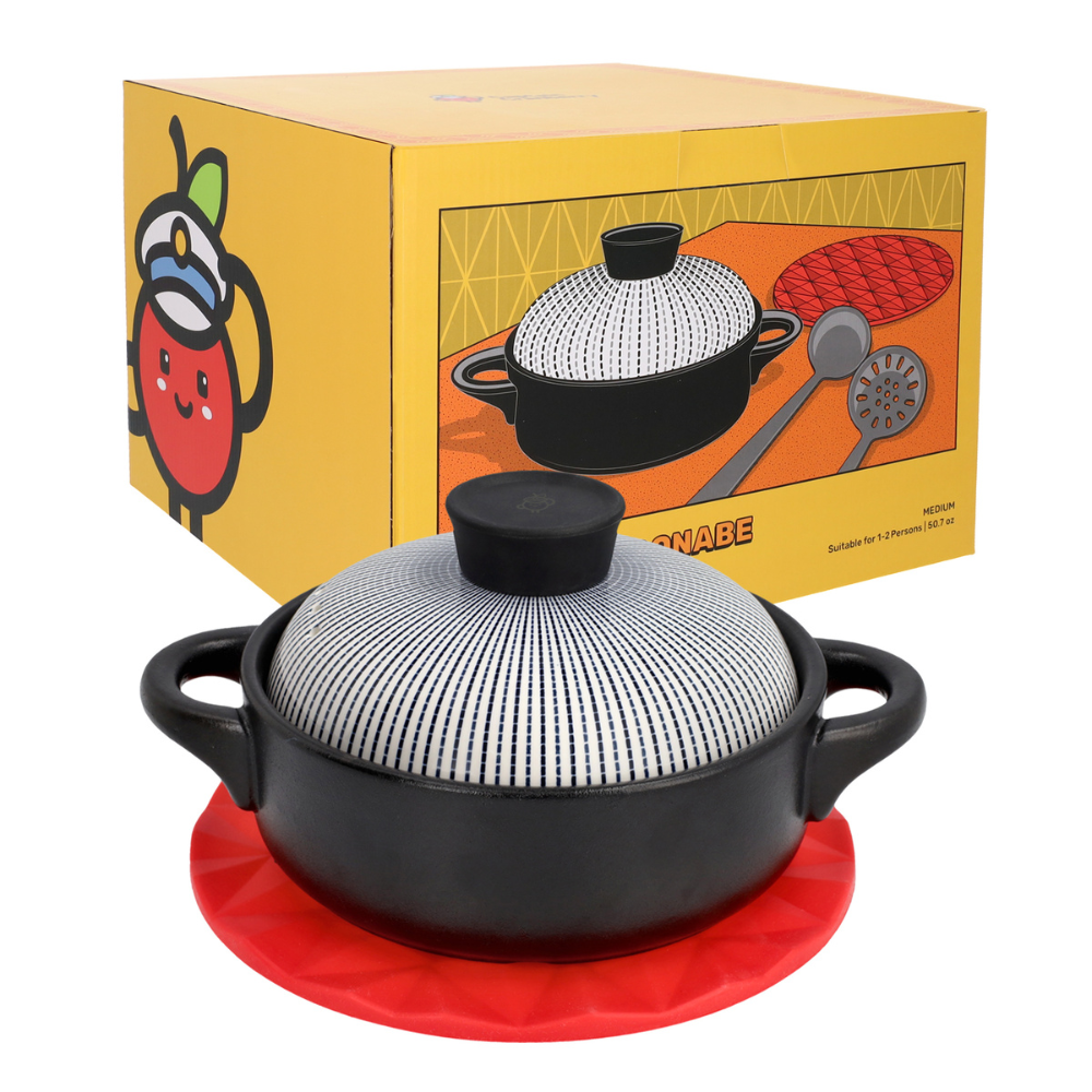 Black pot with lid on a red trivet in front of a yellow box with product illustration